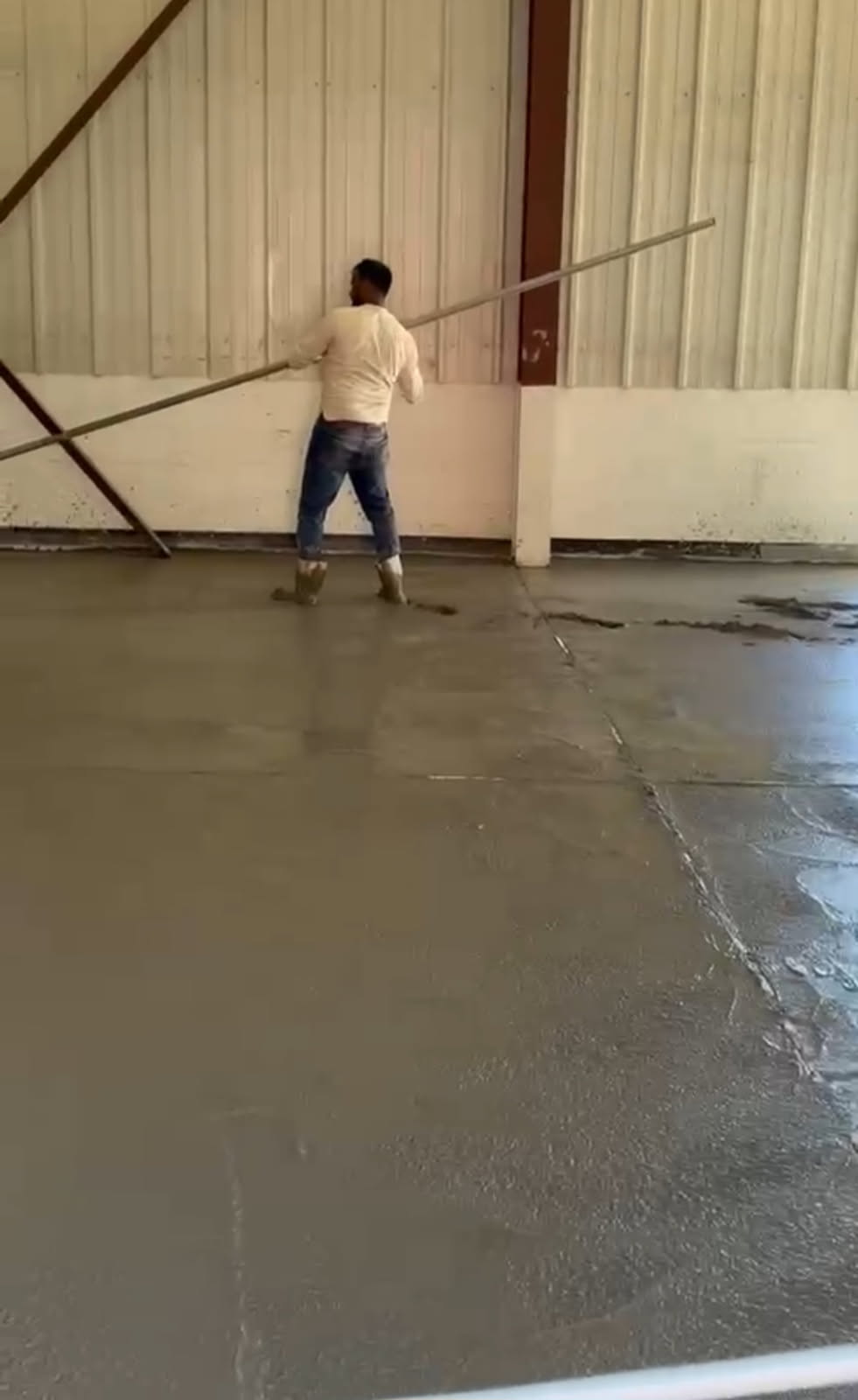 Commercial concrete being screeded and finished