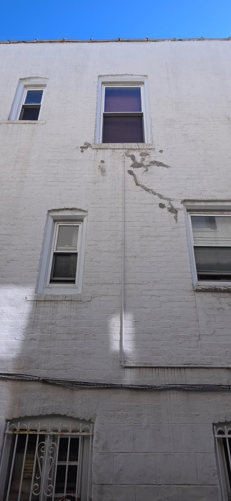Brick pointing and mortar repair on building exterior